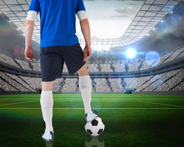 Composite image of football player standing with ball — Stock Photo, Image