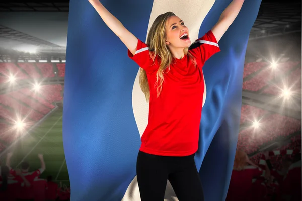 Cheering football fan in red holding honduras flag — Stock Photo, Image