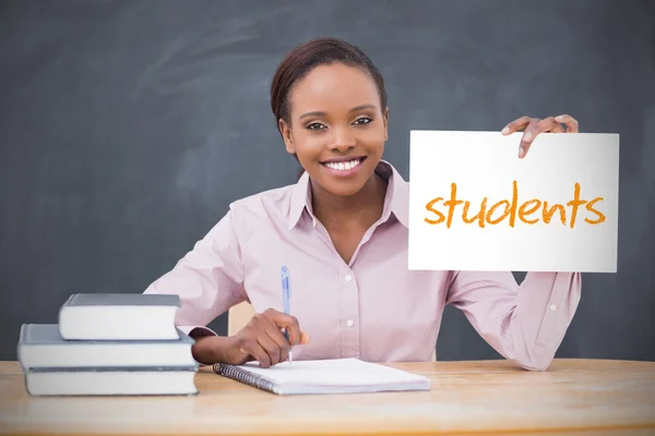 Happy teacher holding page showing students — Stock Photo, Image