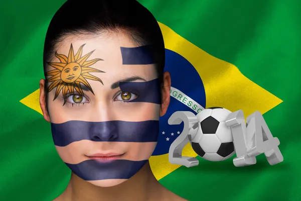 Samengestelde afbeelding van uruguay voetbalfan in gezicht schilderen — Stockfoto