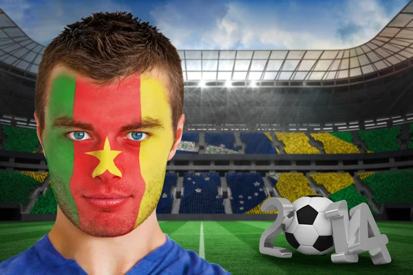 Composite image of serious young cameroon fan with face paint — Stock Photo, Image