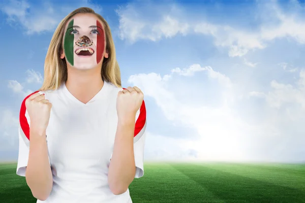 Composite image of excited mexico fan in face paint cheering — Stock Photo, Image