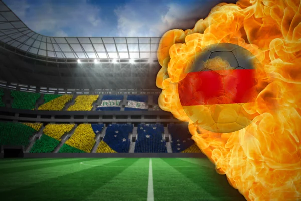 Imagem composta de fogo em torno da bandeira da Alemanha futebol — Fotografia de Stock
