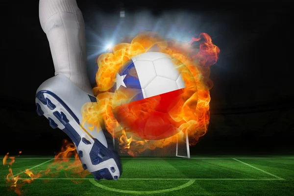 Football player kicking flaming chile flag ball — Stock Photo, Image