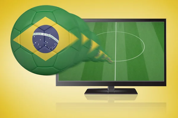 Composite image of football in brasil colours flying out of tv — Stock Photo, Image