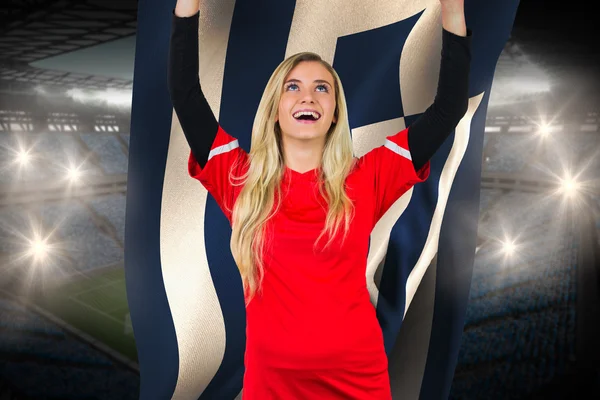 Cheering football fan in red holding greece flag — Stock Photo, Image