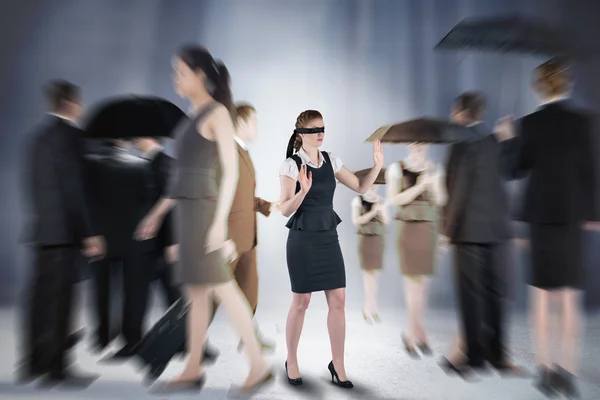 Composite image of redhead businesswoman in a blindfold — Stock Photo, Image