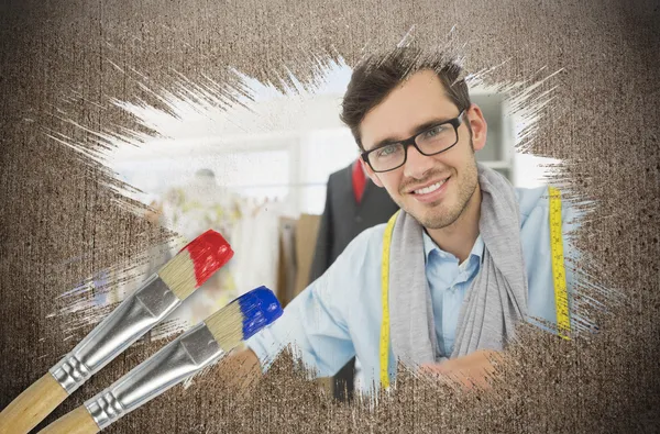 Composite image of fashion designer smiling at camera — Stock Photo, Image