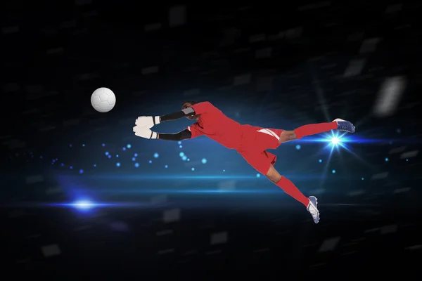 Composite image of goalkeeper in red making a save — Stock Photo, Image