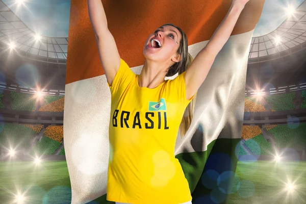 Pretty football fan in brasil t-shirt holding flag — Stock Photo, Image