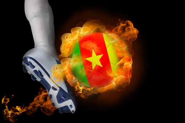 Football player kicking flaming cameroon ball — Stock Photo, Image