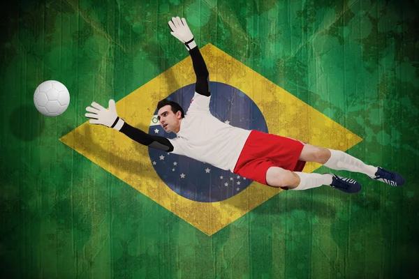 Composite image of goalkeeper in white making a save — Stock Photo, Image