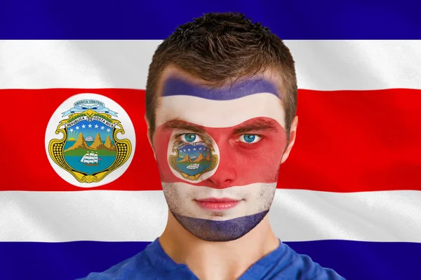 Serious young football fan in face paint — Stock Photo, Image