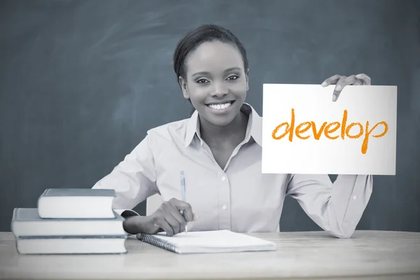 Happy teacher holding page showing develop — Stock Photo, Image