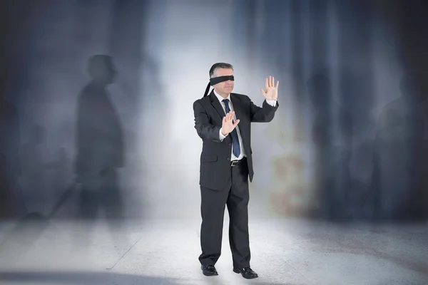 Composite image of mature businessman in a blindfold — ストック写真