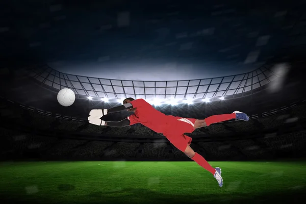 Composite image of goalkeeper in red making a save — Stock Photo, Image