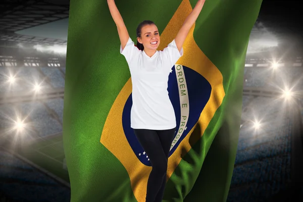 Composite image of excited football fan in white cheering holdin — Stock Photo, Image