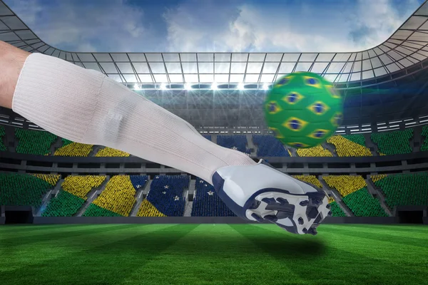 Close up of football player kicking brasil ball — Stock Photo, Image