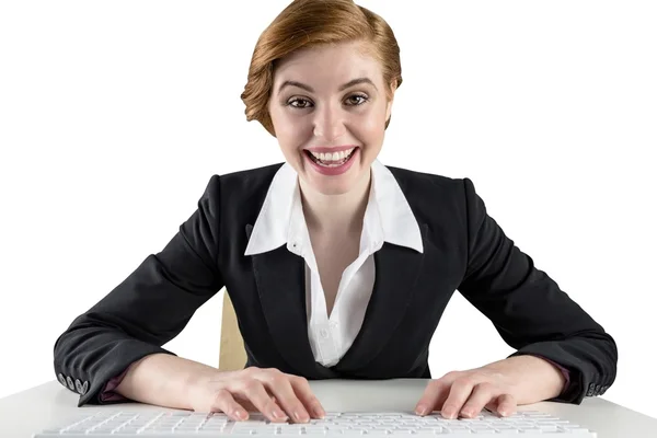 Excited redhead businesswoman sitting at desk — Stock Photo, Image