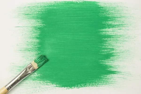 Green paint with paintbrush — Stock Photo, Image