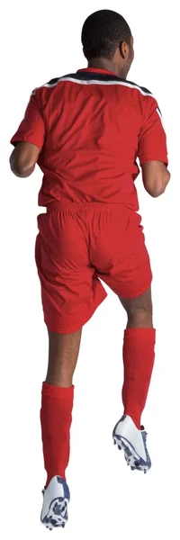 Piłkarz w czerwony skoki — Zdjęcie stockowe