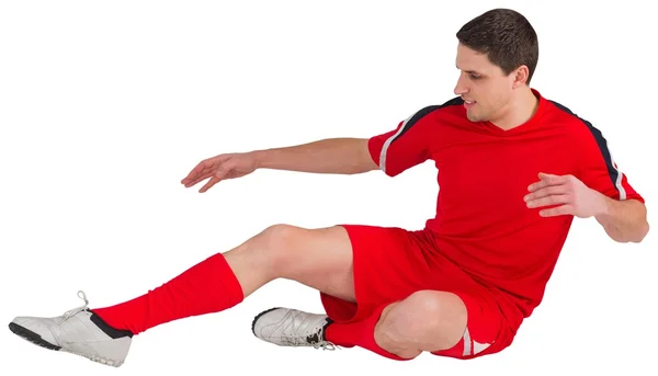 Fit football player jumping and kicking — Stock Photo, Image