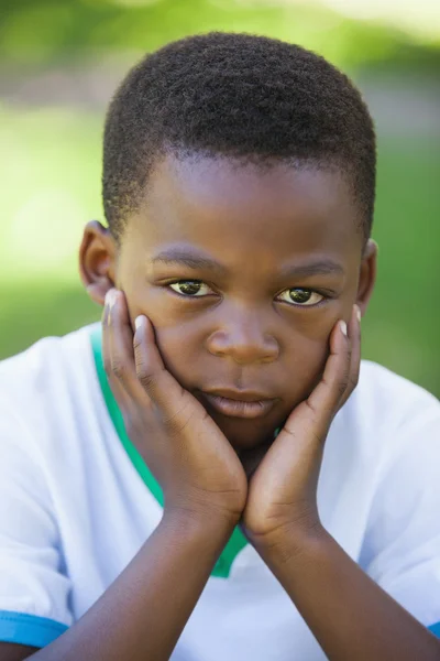 Boy pouting at the camera in the park — Stock Photo, Image