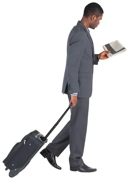 Young businessman pulling his suitcase — Stock Photo, Image
