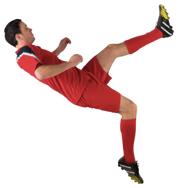 Football player in red kicking — Stock Photo, Image