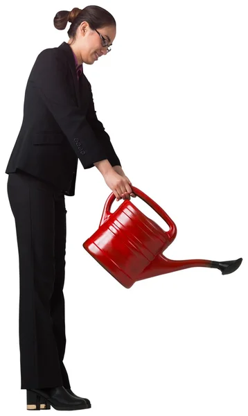 Businesswoman using red watering can — Stock Photo, Image