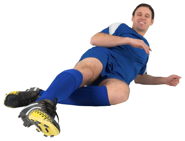 Football player in blue kicking — Stock Photo, Image