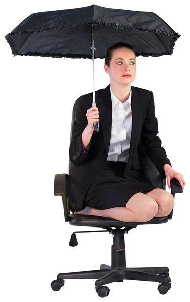 Businesswoman holding a black umbrella — Stock Photo, Image