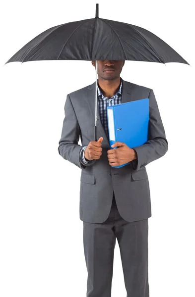 Businessman standing under umbrella — Stock Photo, Image