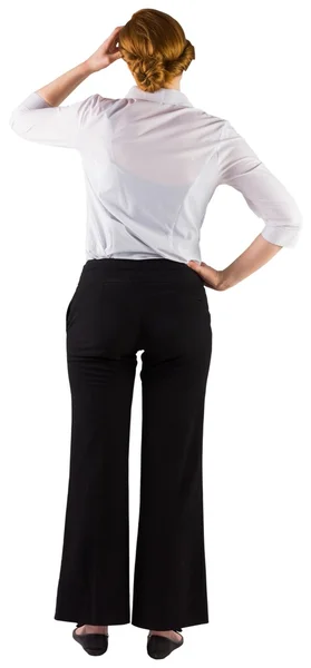 Businesswoman standing with hand on head — Stock Photo, Image