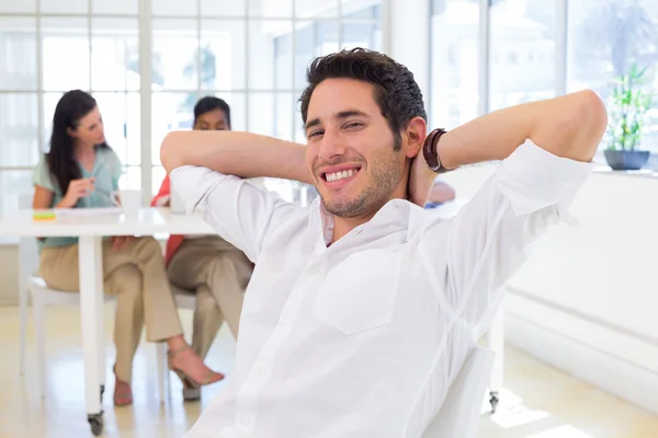 Businessman relaxing with coworkers — Stock Photo, Image