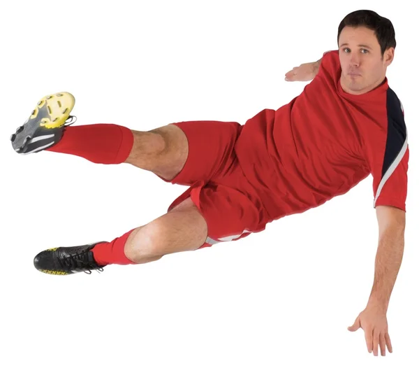 赤い蹴るのフットボール選手 — ストック写真