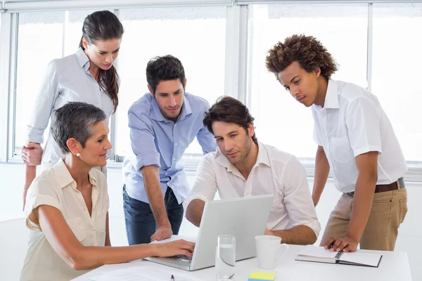Business people looking at laptop — Stock Photo, Image