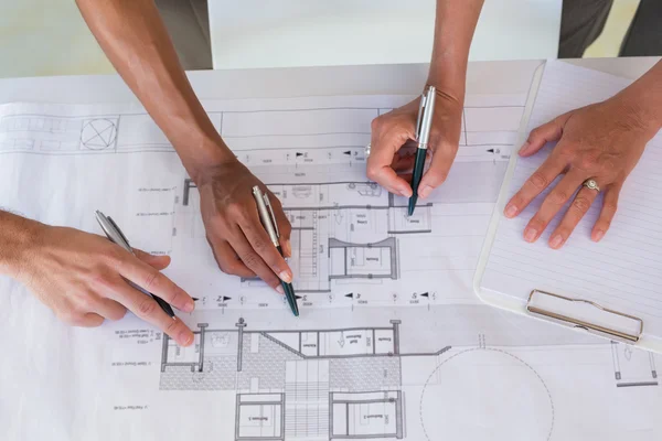 Team of architects going over blueprints — Stock Photo, Image