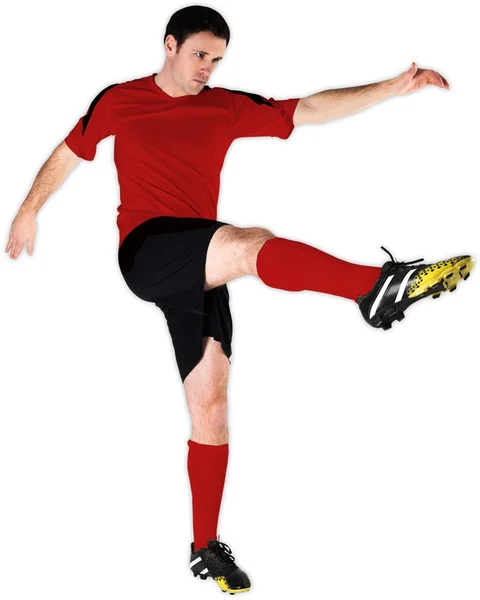 Fotbollsspelare i röda sparkar — Stockfoto