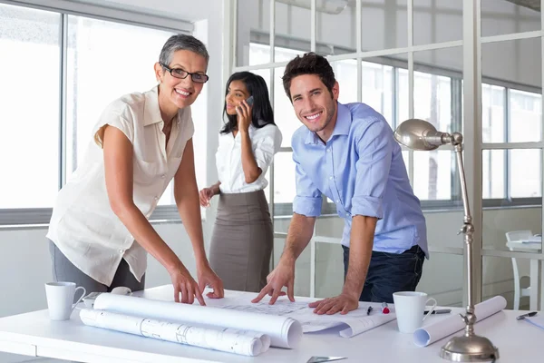 Attractive architects going over plans — Stock Photo, Image