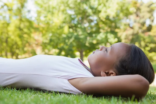 Little girl lying on the grass — Stock Photo, Image
