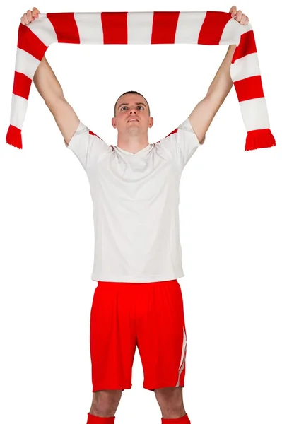 Football player holding striped scarf — Stock Photo, Image