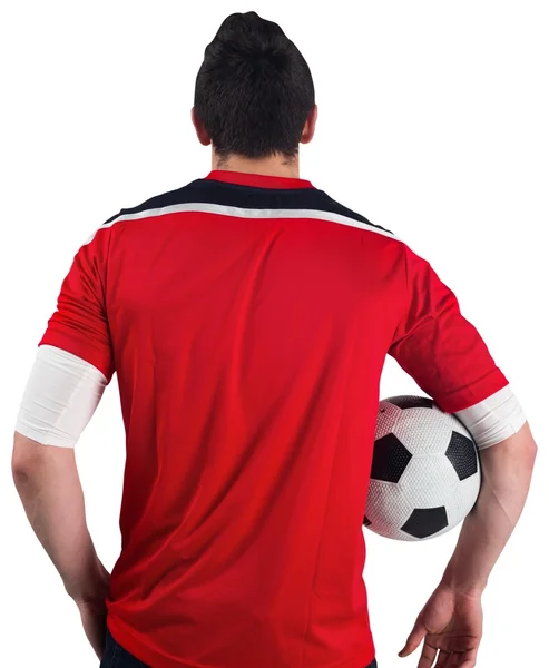 Fotbalový fanoušek v červené držení míče — Stock fotografie