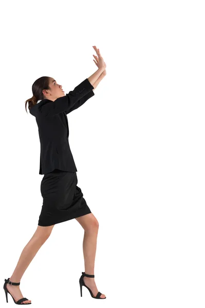 Businesswoman in suit standing and pushing up — Stock Photo, Image