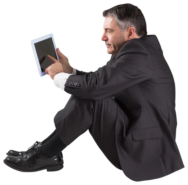 Mature businessman sitting using tablet — Stock Photo, Image