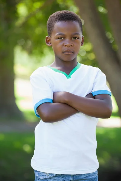 Boy frowning in the park — Stock Photo, Image