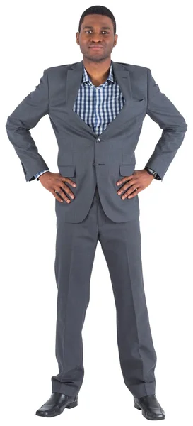 Smiling businessman with hands on hips — Stock Photo, Image
