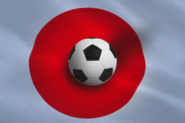 Fotboll mot japan flagga — Stockfoto