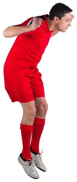 Fit football player jumping up — Stock Photo, Image