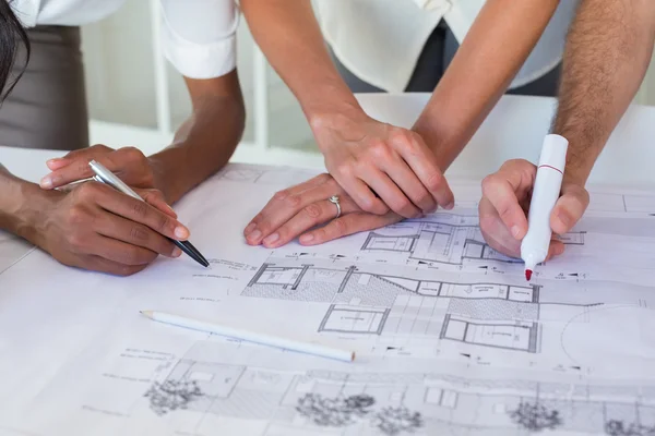 Architects drawing on the blueprints — Stock Photo, Image